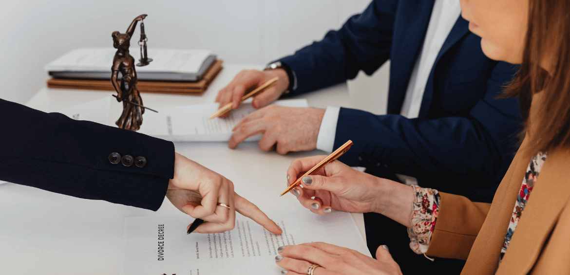 people signing paperwork