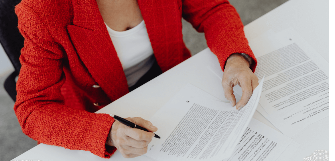 Woman signing paperwork